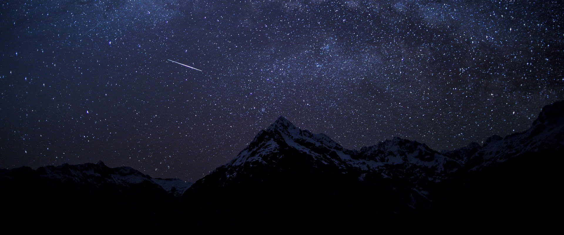 Shooting star over a mountain
